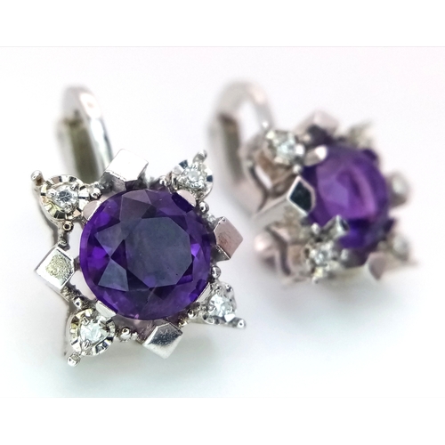 290 - A Pair of 14K Gold, Amethyst and Diamond Earrings. 2 x 1.5ct amethysts with 8, trillion cut diamonds... 