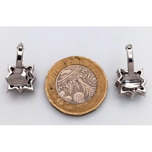 290 - A Pair of 14K Gold, Amethyst and Diamond Earrings. 2 x 1.5ct amethysts with 8, trillion cut diamonds... 