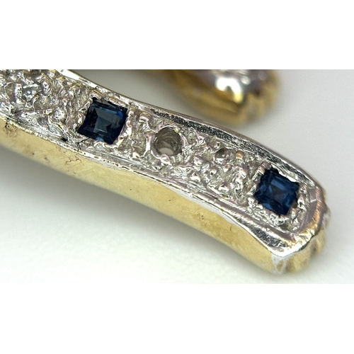 304 - A Playful 9K Gold, Diamond and Sapphire Panther Brooch. 1ctw of diamonds and 0.5ctw of sapphires. 5c... 