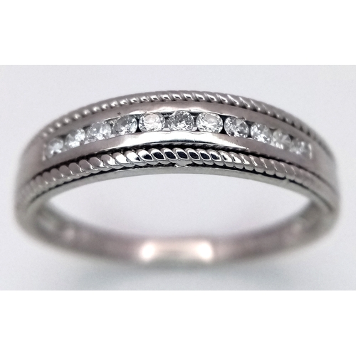 330 - A 9K WHITE GOLD WITH YELLOW GOLD BEADED EDGE DIAMOND SET BAND RING. 0.15CTW, 2.2G TOTAL WEIGHT, SIZE... 