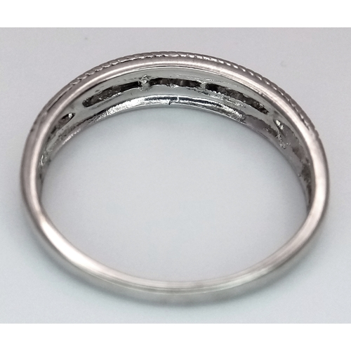 330 - A 9K WHITE GOLD WITH YELLOW GOLD BEADED EDGE DIAMOND SET BAND RING. 0.15CTW, 2.2G TOTAL WEIGHT, SIZE... 