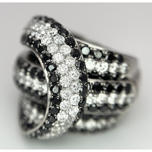 11 - AN 18K WHITE GOLD WHITE & BLACK DIAMOND FANCY CROSSOVER RING. 3.60CT , 14.4G TOTAL WEIGHT , SIZE I. ... 