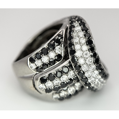 11 - AN 18K WHITE GOLD WHITE & BLACK DIAMOND FANCY CROSSOVER RING. 3.60CT , 14.4G TOTAL WEIGHT , SIZE I. ... 