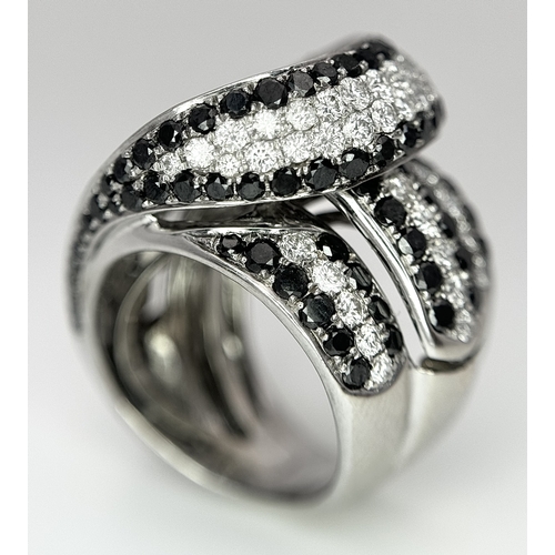 11 - AN 18K WHITE GOLD WHITE & BLACK DIAMOND FANCY CROSSOVER RING. 3.60CT , 14.4G TOTAL WEIGHT , SIZE I. ... 