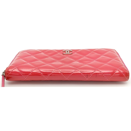 181 - A Chanel Pink Quilted Patent Leather Wallet. Pink quilted patent leather exterior with silver-tone h... 