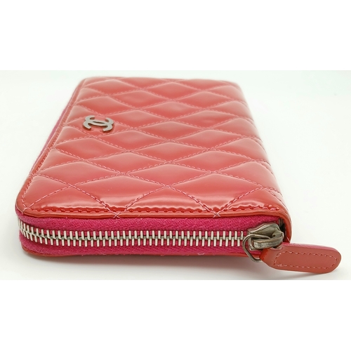 181 - A Chanel Pink Quilted Patent Leather Wallet. Pink quilted patent leather exterior with silver-tone h... 