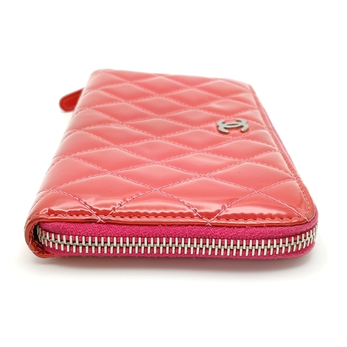 181 - A Chanel Pink Quilted Patent Leather Wallet. Pink quilted patent leather exterior with silver-tone h... 