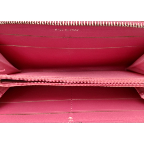 181 - A Chanel Pink Quilted Patent Leather Wallet. Pink quilted patent leather exterior with silver-tone h... 