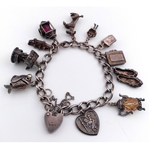 182 - Vintage SILVER CHARM BRACELET. Full UK hallmark with charms to include Lantern, Poodle, Wishing Well... 