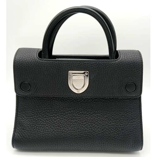 227 - A Christian Dior Black Diorever Handbag. Leather exterior with silver-toned hardware, two rolled lea... 