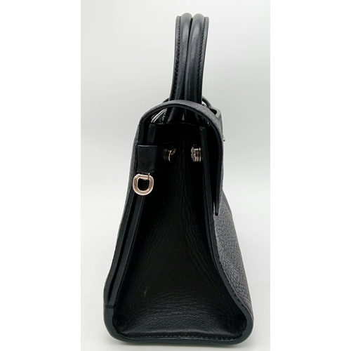 227 - A Christian Dior Black Diorever Handbag. Leather exterior with silver-toned hardware, two rolled lea... 