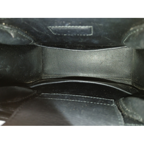 227 - A Christian Dior Black Diorever Handbag. Leather exterior with silver-toned hardware, two rolled lea... 