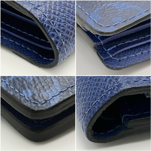 243 - A Louis Vuitton Blue Monogram Eclipse Canvas Bifold Wallet. Blue monogram-printed coated canvas exte... 