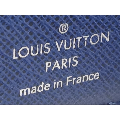 243 - A Louis Vuitton Blue Monogram Eclipse Canvas Bifold Wallet. Blue monogram-printed coated canvas exte... 