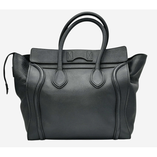 251 - A Céline Black Pebbled Leather Luggage Tote Bag. Black leather exterior with silver-toned hardware, ... 