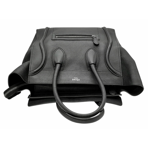 251 - A Céline Black Pebbled Leather Luggage Tote Bag. Black leather exterior with silver-toned hardware, ... 