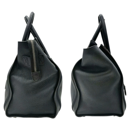 251 - A Céline Black Pebbled Leather Luggage Tote Bag. Black leather exterior with silver-toned hardware, ... 