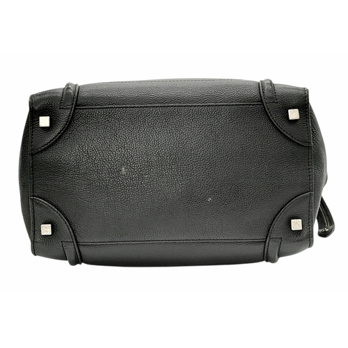 251 - A Céline Black Pebbled Leather Luggage Tote Bag. Black leather exterior with silver-toned hardware, ... 