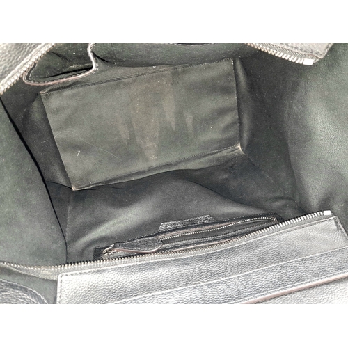 251 - A Céline Black Pebbled Leather Luggage Tote Bag. Black leather exterior with silver-toned hardware, ... 