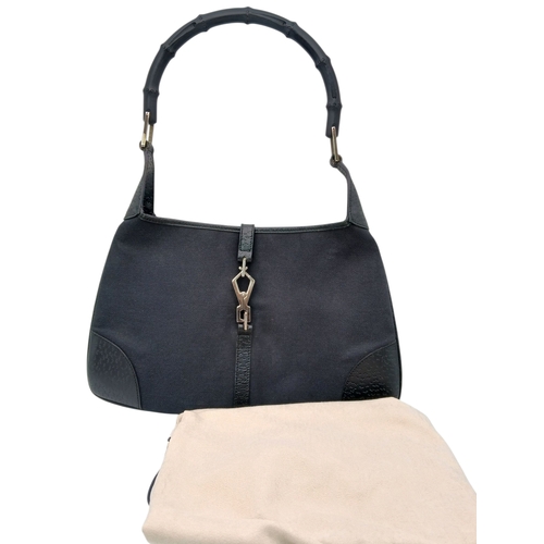 279 - A Gucci Black Canvas and Leather Bamboo-Top Handle Handbag. Black canvas exterior with bamboo-style ... 