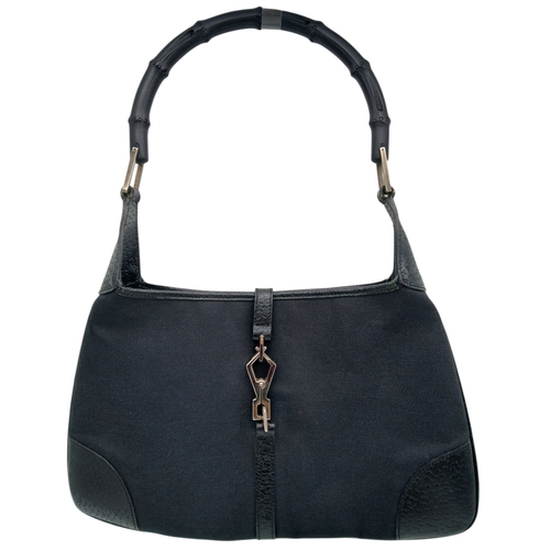 279 - A Gucci Black Canvas and Leather Bamboo-Top Handle Handbag. Black canvas exterior with bamboo-style ... 