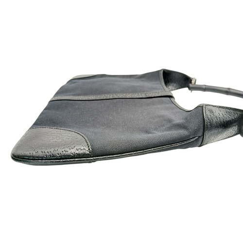 279 - A Gucci Black Canvas and Leather Bamboo-Top Handle Handbag. Black canvas exterior with bamboo-style ... 