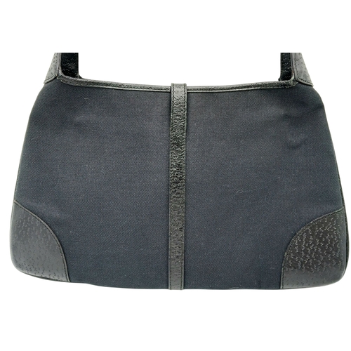 279 - A Gucci Black Canvas and Leather Bamboo-Top Handle Handbag. Black canvas exterior with bamboo-style ... 