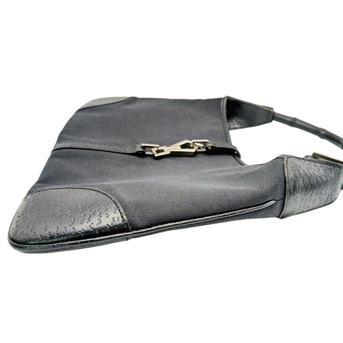 279 - A Gucci Black Canvas and Leather Bamboo-Top Handle Handbag. Black canvas exterior with bamboo-style ... 