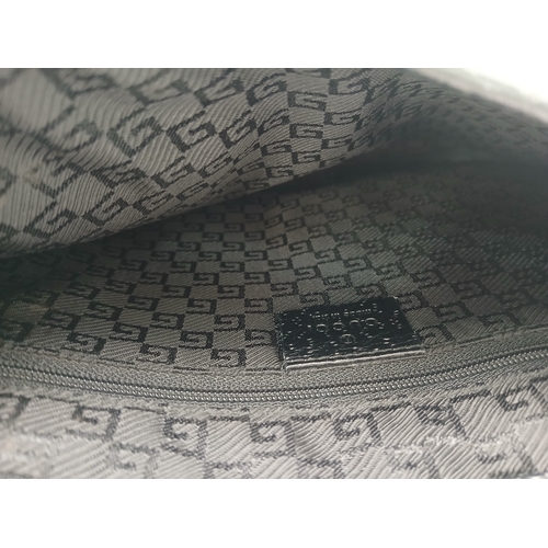 279 - A Gucci Black Canvas and Leather Bamboo-Top Handle Handbag. Black canvas exterior with bamboo-style ... 