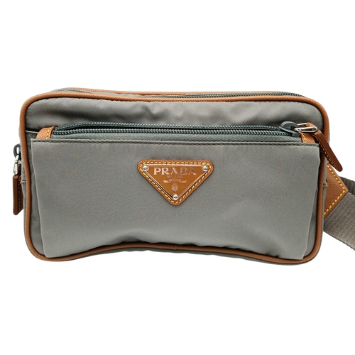 293 - A Prada Grey Nylon and Leather Trim Belt Bag. Grey nylon exterior with tan leather trim, silver-tone... 