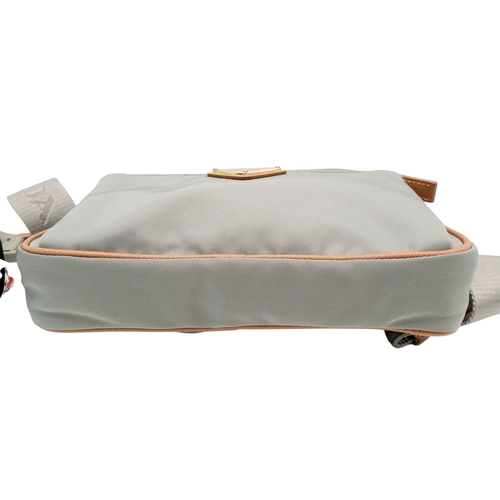 293 - A Prada Grey Nylon and Leather Trim Belt Bag. Grey nylon exterior with tan leather trim, silver-tone... 