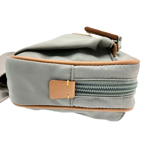 293 - A Prada Grey Nylon and Leather Trim Belt Bag. Grey nylon exterior with tan leather trim, silver-tone... 