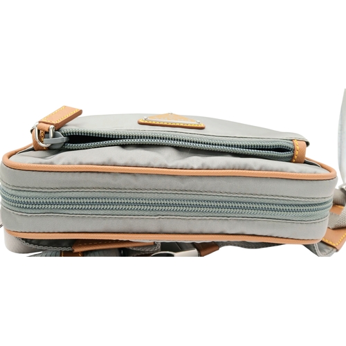 293 - A Prada Grey Nylon and Leather Trim Belt Bag. Grey nylon exterior with tan leather trim, silver-tone... 