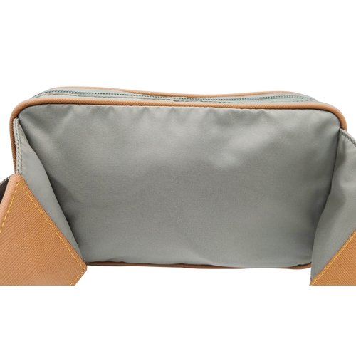 293 - A Prada Grey Nylon and Leather Trim Belt Bag. Grey nylon exterior with tan leather trim, silver-tone... 