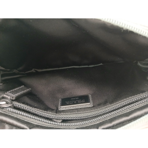 293 - A Prada Grey Nylon and Leather Trim Belt Bag. Grey nylon exterior with tan leather trim, silver-tone... 