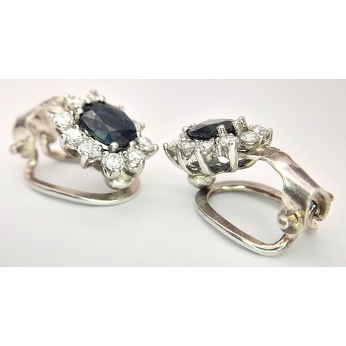 297 - A Pair of 14K Gold, Diamond and Sapphire Earrings. 2 x 1ct oval cut sapphires 2 x 10 round brilliant... 