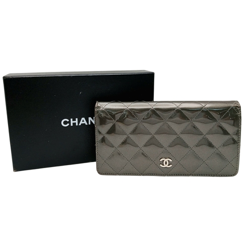 327 - A Chanel Metallic Silver Quilted Patent Leather Wallet. Metallic silver leather exterior with silver... 
