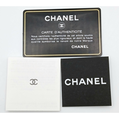 327 - A Chanel Metallic Silver Quilted Patent Leather Wallet. Metallic silver leather exterior with silver... 