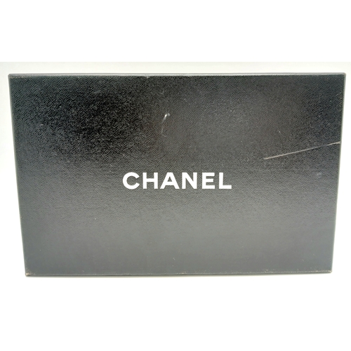 327 - A Chanel Metallic Silver Quilted Patent Leather Wallet. Metallic silver leather exterior with silver... 