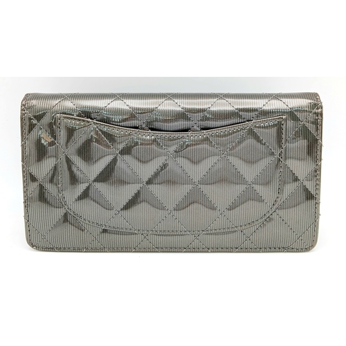 327 - A Chanel Metallic Silver Quilted Patent Leather Wallet. Metallic silver leather exterior with silver... 