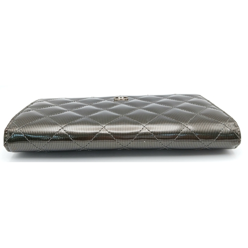 327 - A Chanel Metallic Silver Quilted Patent Leather Wallet. Metallic silver leather exterior with silver... 
