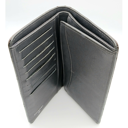 327 - A Chanel Metallic Silver Quilted Patent Leather Wallet. Metallic silver leather exterior with silver... 