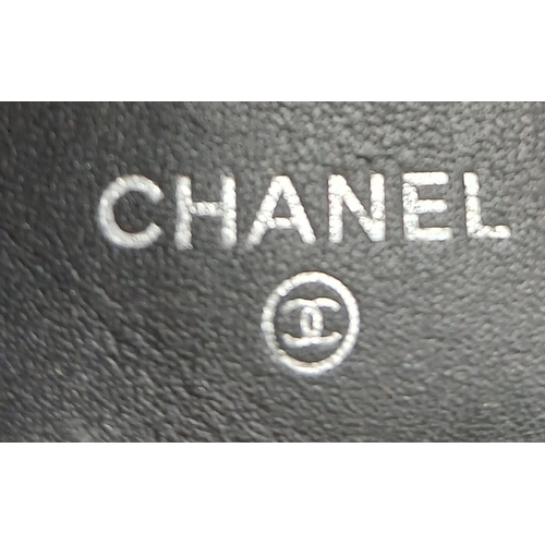 327 - A Chanel Metallic Silver Quilted Patent Leather Wallet. Metallic silver leather exterior with silver... 