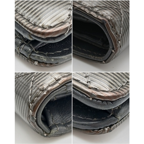 327 - A Chanel Metallic Silver Quilted Patent Leather Wallet. Metallic silver leather exterior with silver... 