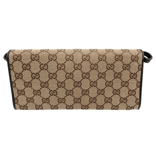 343 - A Gucci Monogram Bamboo Crossbody/Clutch Bag. Canvas exterior with leather trim, silver-toned hardwa... 