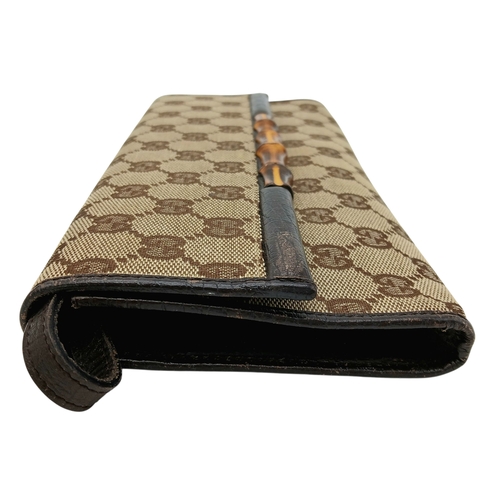 343 - A Gucci Monogram Bamboo Crossbody/Clutch Bag. Canvas exterior with leather trim, silver-toned hardwa... 
