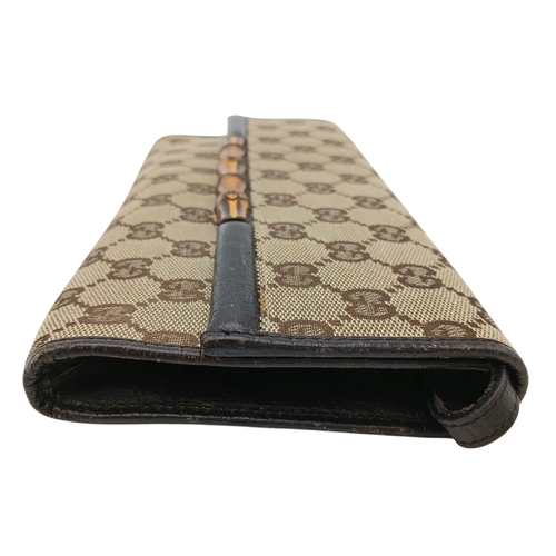 343 - A Gucci Monogram Bamboo Crossbody/Clutch Bag. Canvas exterior with leather trim, silver-toned hardwa... 