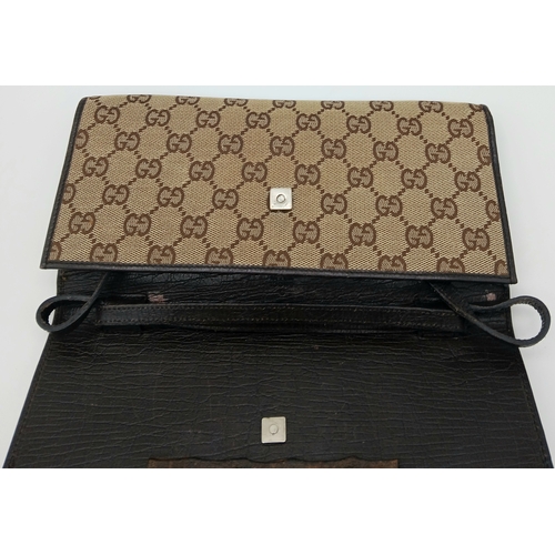343 - A Gucci Monogram Bamboo Crossbody/Clutch Bag. Canvas exterior with leather trim, silver-toned hardwa... 
