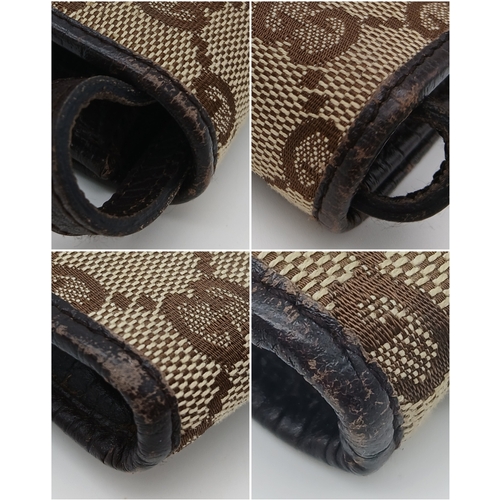 343 - A Gucci Monogram Bamboo Crossbody/Clutch Bag. Canvas exterior with leather trim, silver-toned hardwa... 