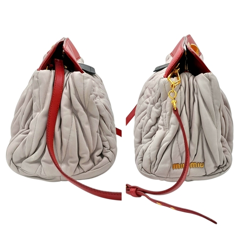 348 - A Miu Miu Matelassé Leather Shoulder Bag. Light purple leather exterior with gold-toned hardware, du... 